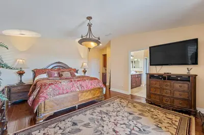 a bedroom with a bed and a flat screen tv at ৎ୭The safty paradiseৎ୭ H/w Pool Jacuzzi &much more in Los Angeles