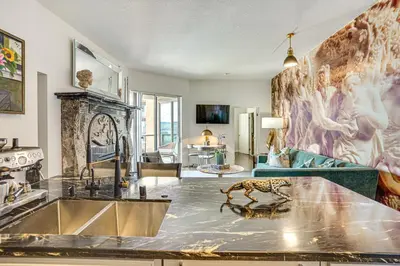 a living room with a kitchen and a living room with a living room at Luxe Long Beach Condo with Pool 1 Mi to Shoreline! in Long Beach