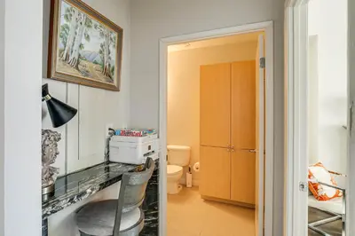 a bathroom with a desk and a chair in a room at Luxe Long Beach Condo with Pool 1 Mi to Shoreline! in Long Beach
