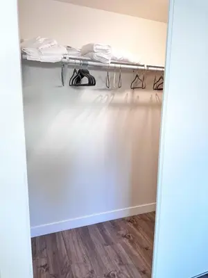 a walk in closet with a white wall at New built house in Los Angeles! in Los Angeles