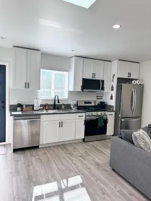 a kitchen with white cabinets and stainless steel appliances at New built house in Los Angeles! in Los Angeles