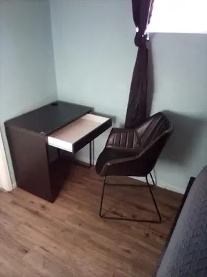 a desk and a chair next to a desk at Robertson's Place Like Home in Los Angeles
