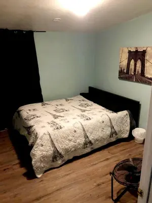 a bedroom with a bed with a comforter on it at Robertson's Place Like Home in Los Angeles