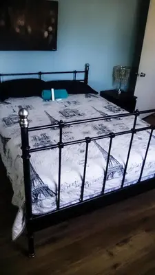 a bedroom with a bed with a black frame at Robertson's Place Like Home in Los Angeles