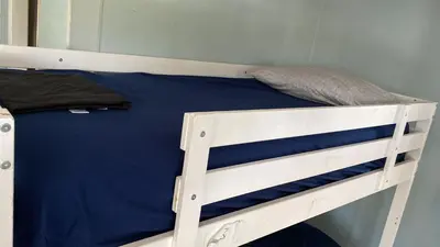 a bunk bed in a room with a blue mattress at Robertson's Place Like Home in Los Angeles
