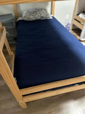 a bed in a room with a blue mattress at Robertson's Place Like Home in Los Angeles