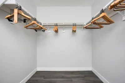 a room with wooden hangers on a wall at Blueground Fairfax pool nr mall dining LAX-1185 in Los Angeles