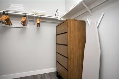 a closet with a wooden cabinet and towels at Blueground Fairfax pool nr mall dining LAX-1185 in Los Angeles