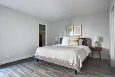 a bedroom with white walls and a large bed at Blueground Fairfax pool nr mall dining LAX-1185 in Los Angeles