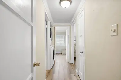 a hallway with white walls and a white door at Valley Glen Getaway in Van Nuys