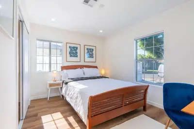 a bedroom with a bed and a blue chair at Acogedora Casa Cerca de Todo in Los Angeles