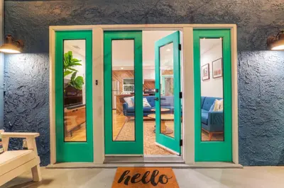 a room with green doors in a living room at Peace palace in Los Angeles