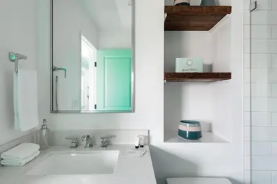 a white bathroom with a sink and a mirror at Peace palace in Los Angeles