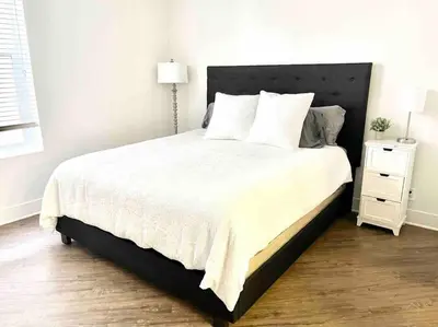 a bedroom with a large bed and a night stand at Spacious 2 Bedroom Venice Beach Villa in Los Angeles