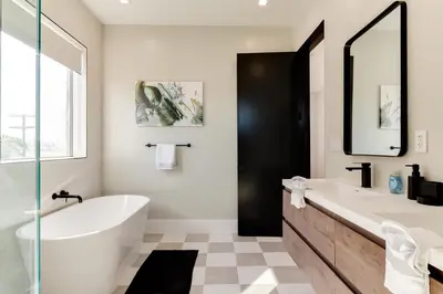 a white bathroom with a tub and a sink at Brand New Modern 9 Bedroom Compound in Pickfair Village in Los Angeles