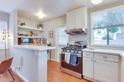 a kitchen with white cabinets and a stove top oven at 1 Mi to Shopping and Dining Central Burbank Duplex in Burbank