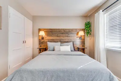 a bedroom with a bed and a wooden wall at 1 Mi to Shopping and Dining Central Burbank Duplex in Burbank