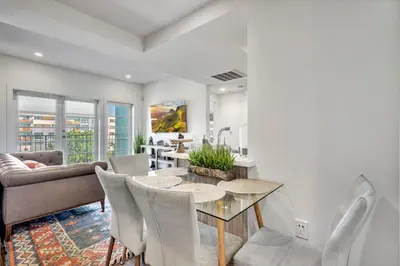 a dining room and living room with a table and chairs at 13 Luxury apartment in Los Angeles