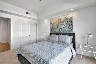 a bedroom with a bed and a painting on the wall at 13 Luxury apartment in Los Angeles