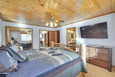a bedroom with a bed and a flat screen tv at Big Bear Lake Cabin with Hot Tub and Gas Fire Pit! in Big Bear Lake