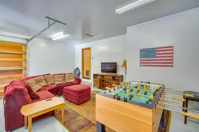 a living room with a couch and a foosball table at Big Bear Lake Cabin with Hot Tub and Gas Fire Pit! in Big Bear Lake