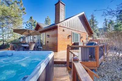a log cabin with a hot tub in the backyard at Big Bear Lake Cabin with Hot Tub and Gas Fire Pit! in Big Bear Lake