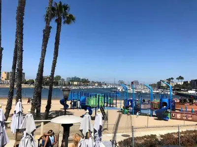 a playground on a beach with palm trees at Nautical 2 Bedroom with Beautiful Ocean Views in Los Angeles