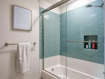 a bathroom with a glass shower with a tub at Private Pool Retreat Near Disney Game Room & Firepit in Fullerton
