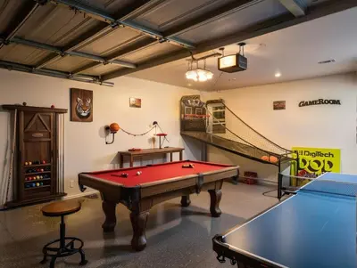 a room with a pool table and a staircase at Private Pool Retreat Near Disney Game Room & Firepit in Fullerton