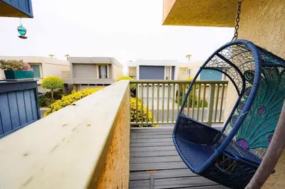 a hammock on a balcony with a swing at SeaView, Pool, HotTub, W/D, Bikes, Gated Community in Port Hueneme