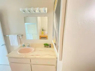 a bathroom with a sink and a mirror at Sea View, Boards, Bikes, W/d in Oxnard
