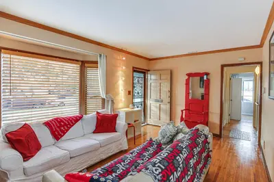 a living room with a white couch and a red chair at Gardena Vacation Rental 5 Mi to Manhattan Beach! in Gardena