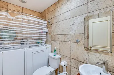 a bathroom with a toilet and a sink at Gardena Vacation Rental 5 Mi to Manhattan Beach! in Gardena