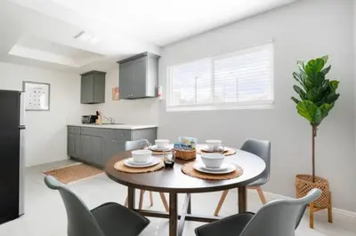 a kitchen with a table and chairs in a room at 5 Mins to DT Alhambra - Homey 2BR Apt 4A in Alhambra