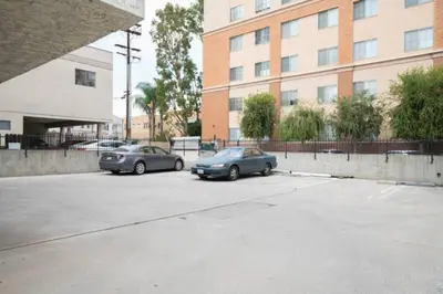 two cars parked in a parking lot in front of a building at 5 Mins to DT Alhambra - Homey 2BR Apt 4A in Alhambra