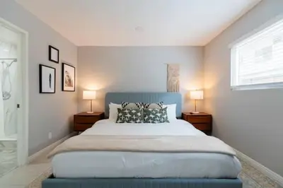 a bedroom with a large bed with two lamps at 5 Mins to DT Alhambra - Homey 2BR Apt 4A in Alhambra