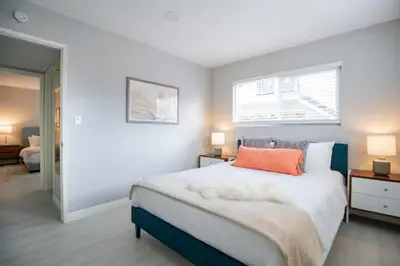 a bedroom with a large bed with an orange pillow at 5 Mins to DT Alhambra - Homey 2BR Apt 4A in Alhambra