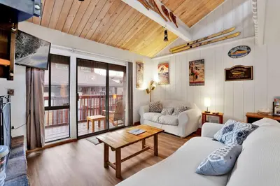 a living room with a couch and a table at Chairlift Lodge Bg Bear~ Walk to Lift Condo~ in Big Bear Lake