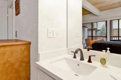 a bathroom with a sink and a mirror at Chairlift Lodge Bg Bear~ Walk to Lift Condo~ in Big Bear Lake