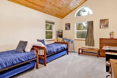 a living room with two beds and a piano at Mount Berkley Big Bear~ Walk to Village~ Games~ in Big Bear Lake