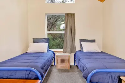 two beds in a room with a window at Mount Berkley Big Bear~ Walk to Village~ Games~ in Big Bear Lake