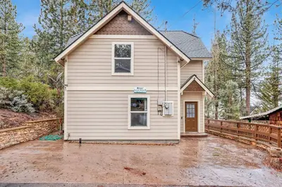 a white house with a driveway in front of it at Mount Berkley Big Bear~ Walk to Village~ Games~ in Big Bear Lake