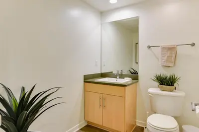 a bathroom with a white toilet and a sink at Wake Up to Spectacular Marina Views in this 2 Bedroom Condo in Los Angeles