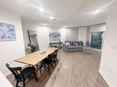 a living room with a table and chairs and a couch at Wake Up to Spectacular Marina Views in this 2 Bedroom Condo in Los Angeles