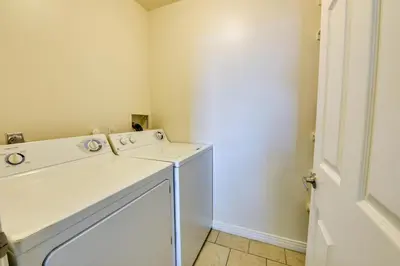 a bathroom with a sink and a washing machine at Marina Life: Smell the Sea, Feel the Breeze in Los Angeles