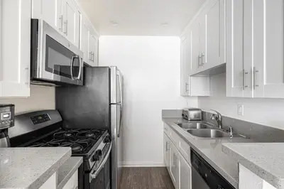 a kitchen with white cabinets and a stainless steel refrigerator at Westwood 1BR w Gym Pool Spa nr UCLA LAX-265 in Los Angeles