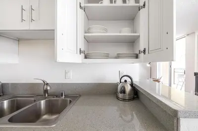 a kitchen with white cabinets and a sink at Westwood 1BR w Gym Pool Spa nr UCLA LAX-265 in Los Angeles