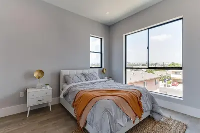 a bedroom with a bed and a large window at Luxury Modern 4 Bedroom 4 Bathroom Home with Rooftop Deck #4 in Los Angeles