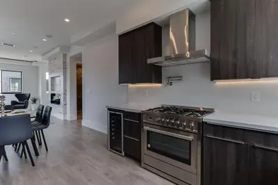a kitchen with a stove and a dining room at Luxury Modern 4 Bedroom 4 Bathroom Home with Rooftop Deck #4 in Los Angeles