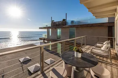 a balcony with a table and chairs and the ocean at Malibu Best Kept Secret in Malibu